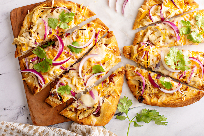 Barbecue chicken flatbreads with hot sauce and red onion