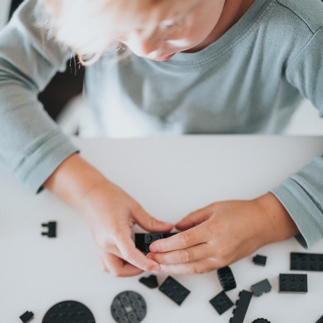 Person creating with LEGO bricks